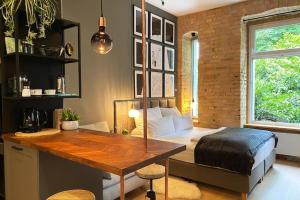 a bedroom with a bed and a desk and a table at Berlin Style Apartments in Berlin