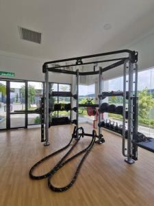 a gym with two tread machines in a room at 4 Traders Garden 1 Bedroom Pool View Netflix WiFi in Cheras