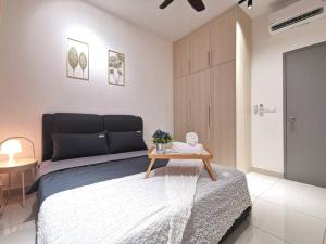 a bedroom with a bed with a table on it at 4 Traders Garden 1 Bedroom Pool View Netflix WiFi in Cheras