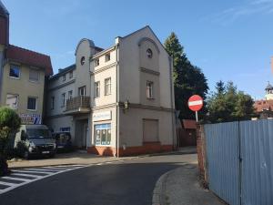 a building on a street with a do not enter sign at Apartamenty Wałowa 11 in Leszno