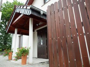 a wooden entrance to a house with a wooden gate at Agroturystyka Zaborski Sad in Zabór