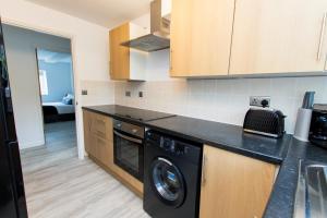 a kitchen with a washer and dryer on a counter at K Suites - Flat 110 Fulbridge Road in Peterborough