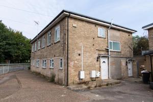 an old brick building with a white door at K Suites - Flat 110 Fulbridge Road in Peterborough