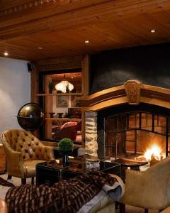 a living room with a fireplace and a couch at Park Gstaad in Gstaad