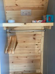 a wooden cabinet with wooden utensils on it at Craigend Farm Holiday Pods - The Woolly Sheep in Dumfries