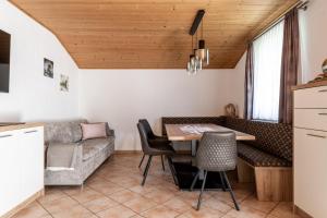 a living room with a table and a couch at Gschwendtners Apartment in Werfenweng