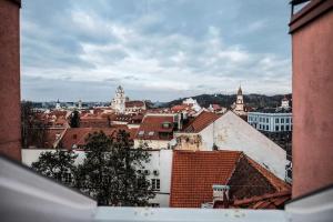 a view of a city with roofs and buildings at #stayhere - Spacious Luxury Town Hall 3BDR Apartment in Vilnius