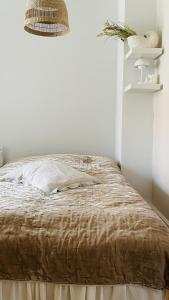 a bed in a white room with a brown blanket at ApartmentInCopenhagen Apartment 1511 in Copenhagen