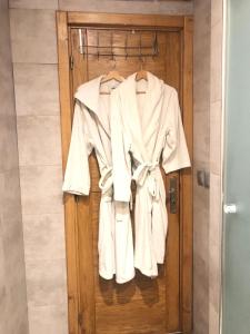a robe hanging on a door in a bathroom at Residence Boule d'OR- EMPLACEMENT - NETFLIX - FREE PARKING in Casablanca