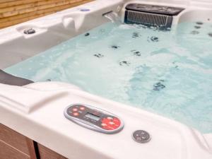 a bath tub with a remote control in it at Ashley Place in Southport