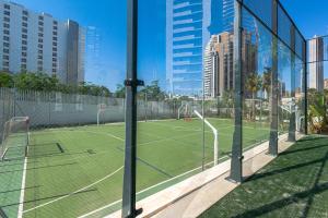 a tennis court in a city with buildings at SUNSET WAVES sea & sky apartment in Benidorm