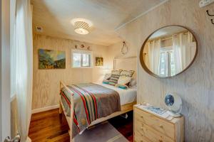 a small bedroom with a bed and a mirror at Truly Tahoe in Homewood