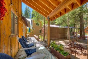 a patio with blue chairs on a house at Truly Tahoe in Homewood