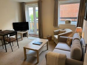 a living room with a couch and a table at Number 10 Serviced Apartment - Chapel in Southampton