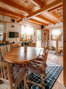 a kitchen and dining room with a wooden table and chairs at Kispatak Vendégház in Zebegény +16 photos
