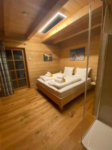 a bedroom with a bed in a wooden room at Holzknechthütte in Lachtal