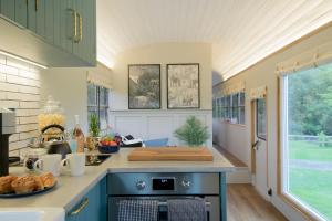 a kitchen with a blue island with a counter top at American School Bus Retreat with Hot Tub in Sussex Meadow in Uckfield