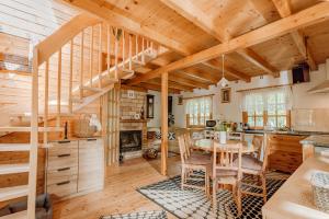 a kitchen with wooden ceilings and a table and chairs at Kispatak Vendégház in Zebegény