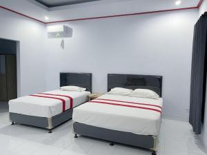 Postel nebo postele na pokoji v ubytování Taman Ratih Guest House