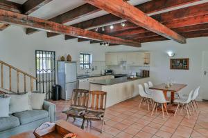 a kitchen and living room with a couch and a table at DE VISSCHUUR in Paternoster