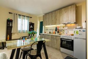 a kitchen with a table and some chairs in it at Terpno Apartment in Leonidio