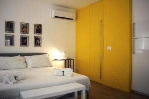 a bedroom with a bed and a yellow door at Mono in Modica