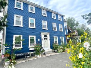 a blue house with flowers in front of it at Northey Street House in Salem