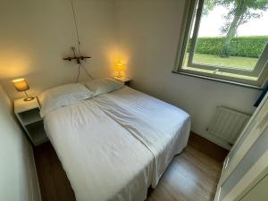 Postel nebo postele na pokoji v ubytování Vakantiebungalow Deltona