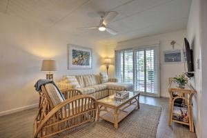 a living room with a couch and a table at Colorful Oceanside Condo with Beach Access! in Saint Augustine Beach