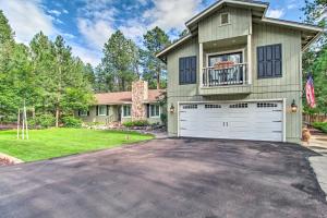 a large house with a white garage at Cozy Pinetop Retreat with Yard and Heated Gazebo! in Indian Pine