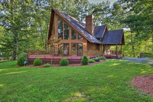 a home with a gambrel roof and a large yard at Majestic Caldwell Retreat with Wraparound Deck! in Caldwell