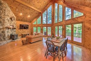 a living room with a table and chairs and a fireplace at Majestic Caldwell Retreat with Wraparound Deck! in Caldwell