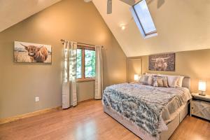 a bedroom with a large bed and a window at Majestic Caldwell Retreat with Wraparound Deck! in Caldwell