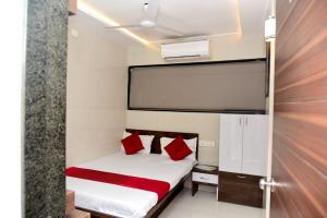 a small bedroom with a bed and a large screen at Nivant Lodge in Solapur