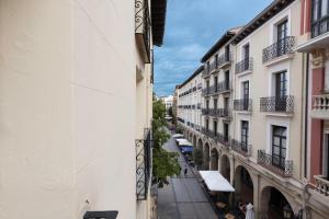 an empty street in a city with buildings at Casa Ochoa in Logroño