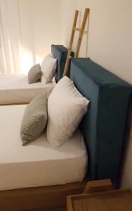 two beds with pillows sitting next to each other at Byron House in Parga