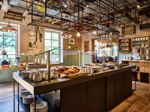 a large kitchen with a buffet of food at Bio-Hotel Zur Mühle in Bad Schandau