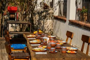 a long wooden table with plates of food on it at Ex Hacienda San José in Oaxaca City