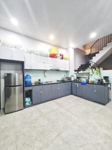 a large kitchen with blue cabinets and a staircase at WELKOM INN in Can Tho