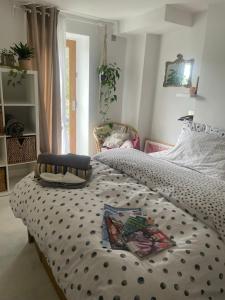 a bedroom with a bed with a black and white comforter at The Cottage, Ashfield Place in Bristol