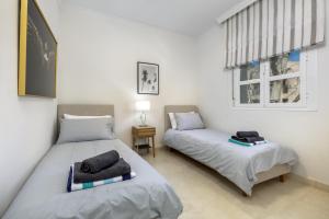 a bedroom with two beds and a window at Villa La Perla by Finest Rentals in Marbella +52 photos