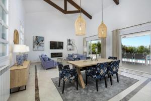 a dining room and living room with a table and chairs at Villa La Perla by Finest Rentals in Marbella