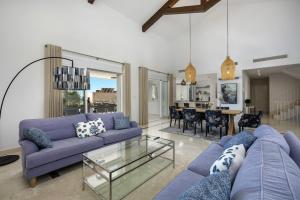 a living room with a purple couch and a glass table at Villa La Perla by Finest Rentals in Marbella