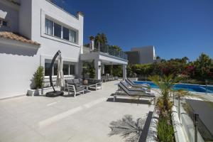 a large white house with a swimming pool at Villa La Perla by Finest Rentals in Marbella