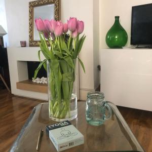 a vase of pink tulips sitting on a table at The Cottage, Ashfield Place in Bristol
