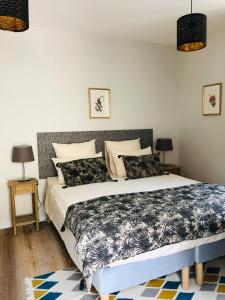 1 dormitorio con 1 cama grande y 2 lámparas en Maison Tassigny en Meursault