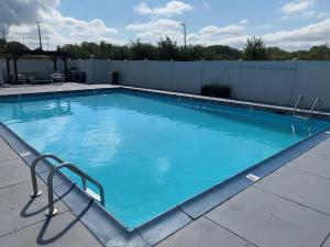 a large swimming pool with blue water at Comfort Inn & Suites Pottstown Eastern Gateway in Pottstown
