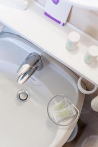 a bathroom sink with a faucet and a bowl on it at Hotel San Rocco in Livigno