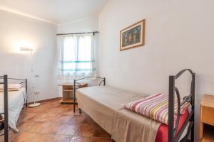 A bed or beds in a room at Trivano Panoramico Villasimius