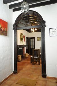 an archway in a room with a chair and a fireplace at Mascotas 2 in Benaocaz